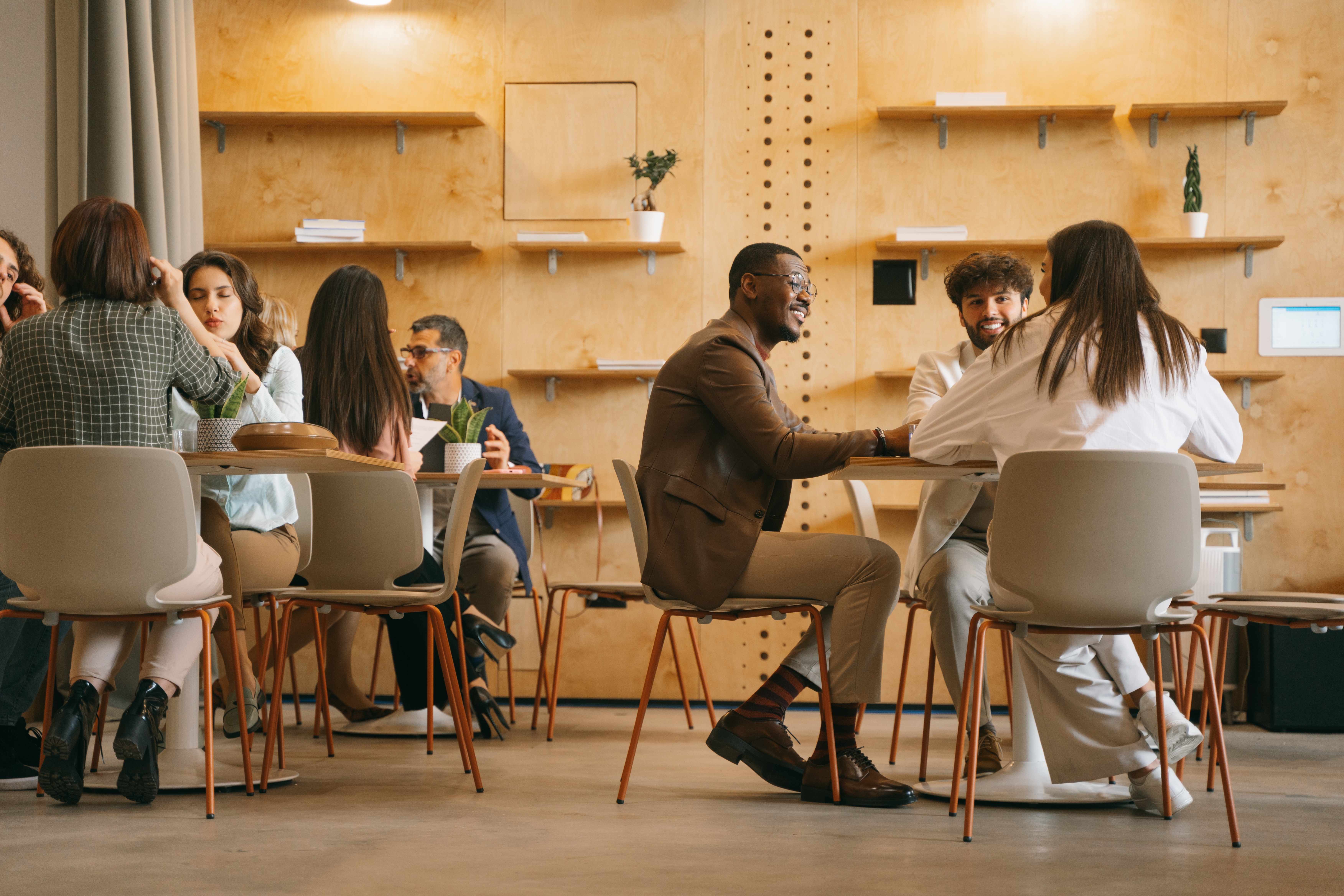a group of young professionals meets at a modern coffee shop for an informal networking meet up